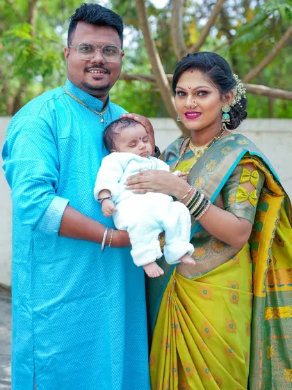 A classic family portrait with their newborn, capturing the joy and completeness of their new family of three.
