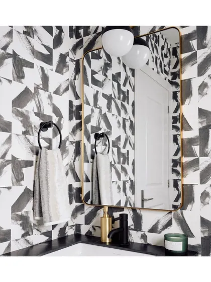 This abstract, brushstroke wallpaper in black and white is a sophisticated and artistic choice for a powder room. It creates a dynamic, graphic backdrop that feels both modern and timeless.