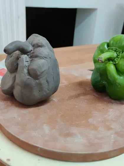 A student's finished but un-fired capsicum sculpture. It has a wonderful, quirky character that is unique to its creator.