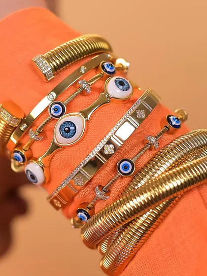 Another view of the ultimate statement stack, showing off the texture of the twisted bangles and the sparkle of the studded evil eye pieces.