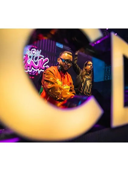 A creative shot through the 'ACDMF' letters, showing me and DJ Andre performing.