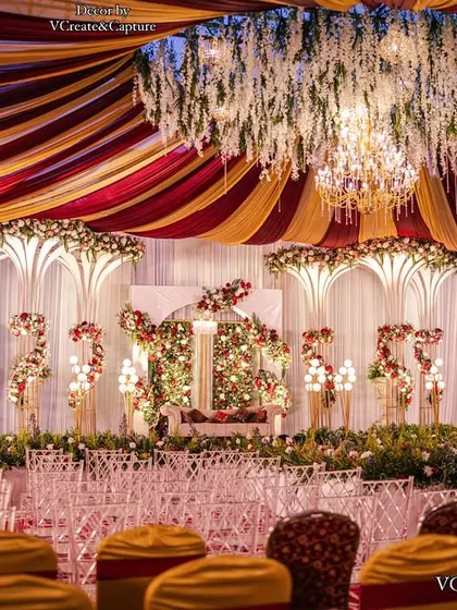 Another angle of the grand red and gold reception, showing the seating arrangement and the impressive scale of the decor.