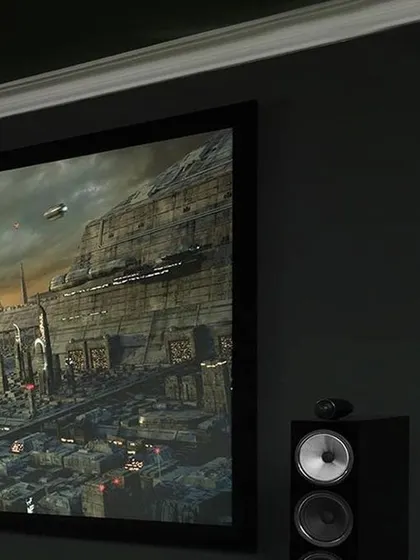 Experience audio excellence with Bowers & Wilkins. This close-up shows a B&W tower speaker next to a projection screen, delivering precise and powerful sound for an immersive sci-fi movie experience.