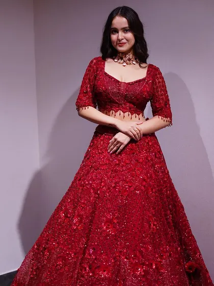 This deep maroon lehenga is all about the details. The tone-on-tone embroidery and sequin work create a subtle yet incredibly rich look, perfect for an evening reception.