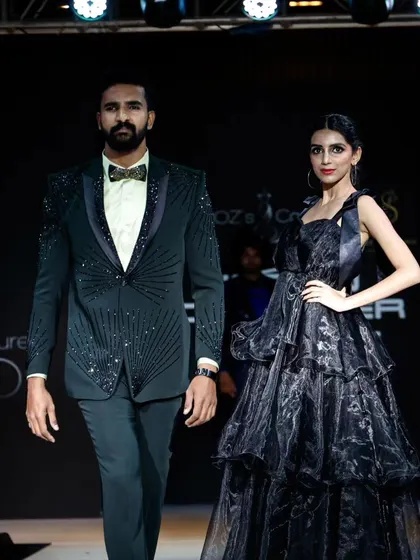 A male and female model showcasing elegant evening wear. My productions for the Indian Designer League often feature both menswear and womenswear, requiring careful coordination and styling.
