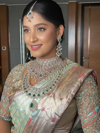A smiling portrait of the bride, her happiness radiating and her look a perfect blend of modern and traditional.