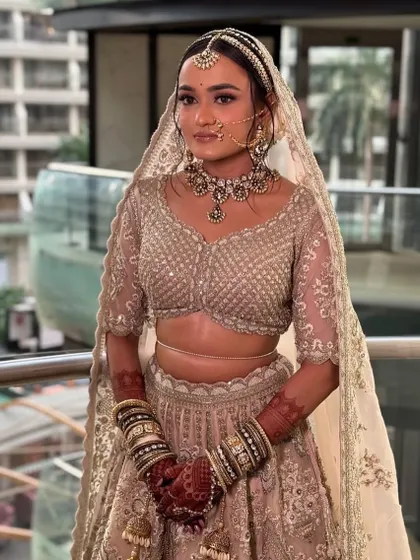 The bride with her dupatta set over the floral bun, ready for her ceremony.