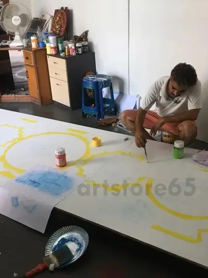 The initial stages of a Lippan art project, with the base design being sketched and painted onto the board.