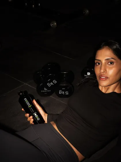 A direct-to-camera shot while rehydrating during a workout. Proper hydration is one of the most important and often overlooked aspects of performance and recovery.