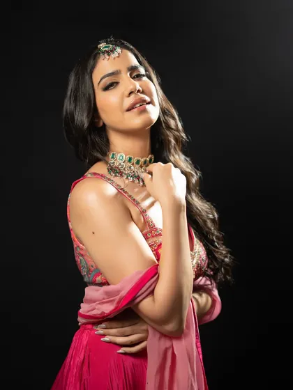 A studio shot against a black background, making the vibrant colors of this pink and red outfit pop. This style is great for creating a dramatic lookbook.