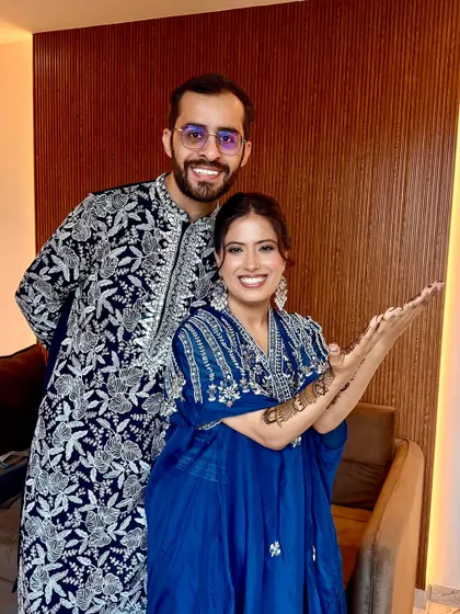 A happy couple at their Mehendi. Her makeup is fresh and natural, perfect for a fun, relaxed celebration.