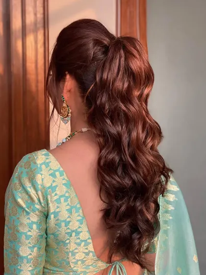 A beautiful wavy ponytail for the bride's sister. It's a chic and elegant choice that keeps hair off the face while still showing off gorgeous length and texture.
