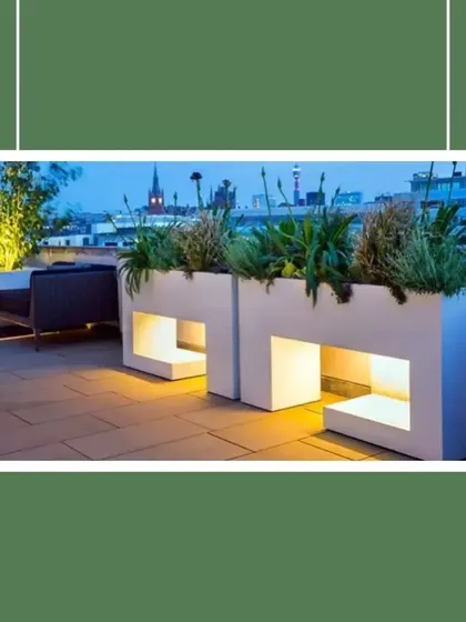 Planters can be more than just pots for plants. These modern, illuminated planters double as architectural elements and subtle light sources, adding a sophisticated and functional touch to a rooftop terrace at night.