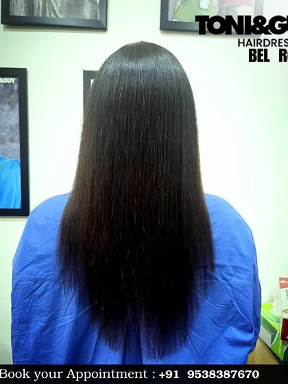 A classic V-cut haircut on long, straight, dark hair. This cutting technique helps to create the illusion of length while removing split ends and maintaining a structured shape.