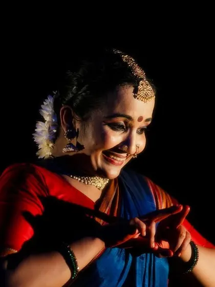 A close-up shot from 'Naga Mandala' capturing a moment of joy and connection between the performers.
