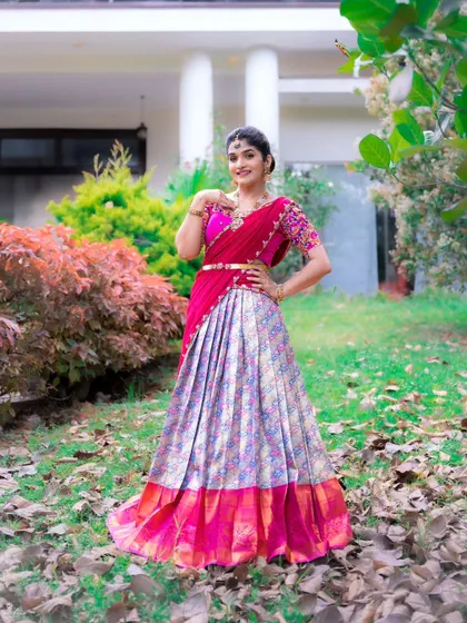 A vibrant half saree in pink and a multi-colored brocade lehenga, perfect for a festive celebration.