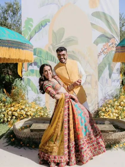 A playful moment at the poolside Haldi in Marrakech. The decor featured a custom hand-painted backdrop with a lemon and banana leaf motif, adding a touch of tropical fun to the Moroccan setting.