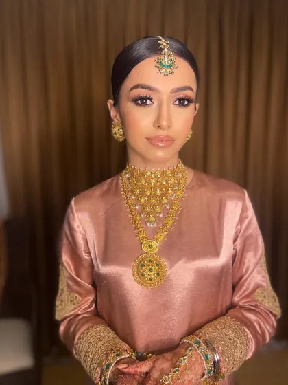 The final look for Pawlin's Anand Karaj. The minimalist makeup allows her natural beauty and the stunning gold jewelry to take center stage.