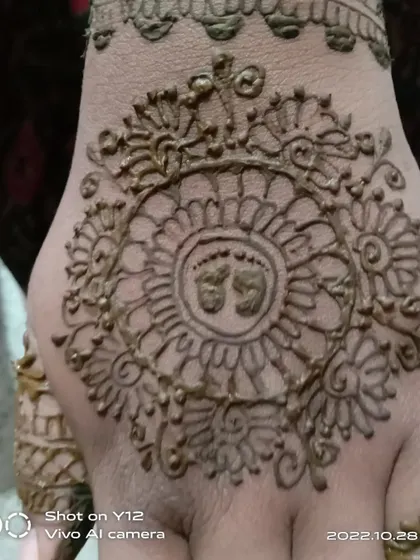 A close-up of a baby shower mandala design, with tiny baby footprints right in the center. It's these small, thoughtful details that make your mehendi unique and memorable.