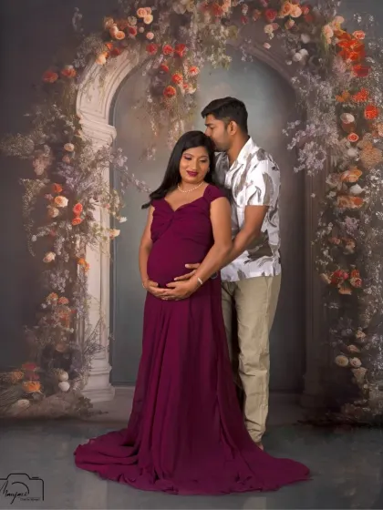 The protective and loving embrace of a partner. This portrait beautifully showcases the couple's bond as they await their new arrival.