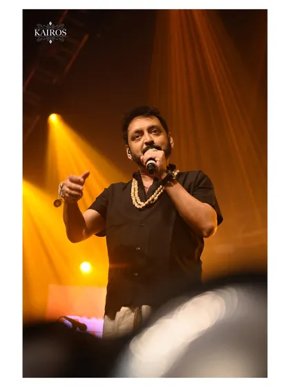 A musician on stage, bathed in warm golden light. My concert photography focuses on capturing the artist's connection with their music and the audience.