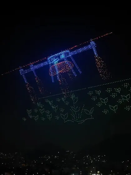A complex formation of a large drone carrying butterflies, another one of our record-breaking designs. This showcases our ability to create intricate and meaningful aerial images.