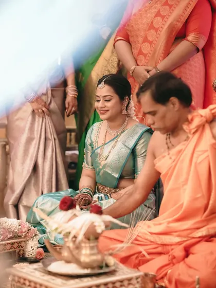 A bride participates in a traditional South Indian wedding puja, a moment of serene devotion.
