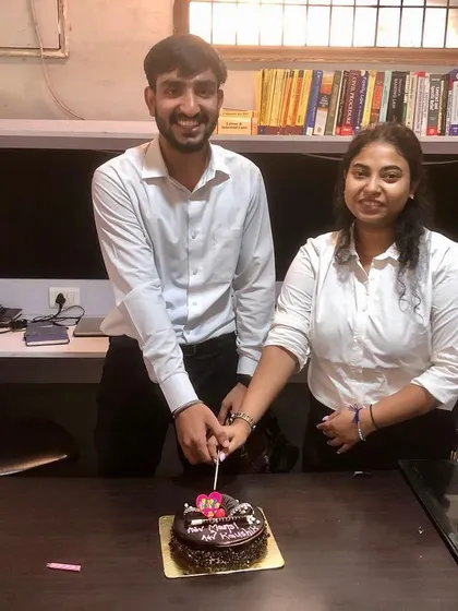 Our team members cutting their birthday cake at the office. Celebrating these milestones together is an important part of our firm's culture.