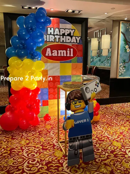 See more of the Lego-themed setup, including a custom cake stand and different angles of the vibrant balloon and backdrop combination.