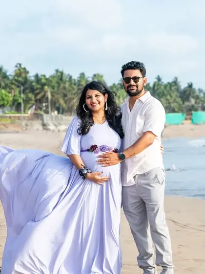 The flowing lavender gown catches the sea breeze perfectly in this beach maternity photo. It adds a sense of movement and grace, highlighting the beauty of the mother-to-be.