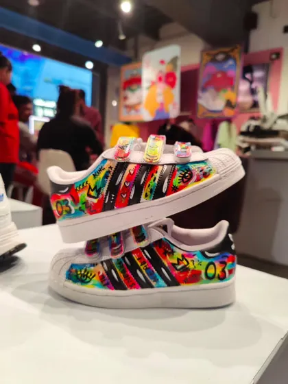 Even the kids' shoes got a custom touch! I painted these children's Superstars with a vibrant, graffiti-style design.