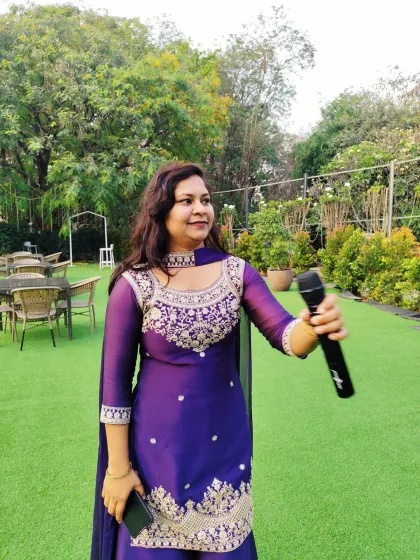 Mic in hand, ready to kick off the next activity. My job as an engagement party host is to keep the event flowing smoothly and ensure there's never a dull moment.