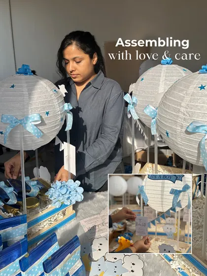 Assembling with love and care. Here I am putting together the 'It's a Boy' announcement hampers, making sure every element of the celestial theme is just right.