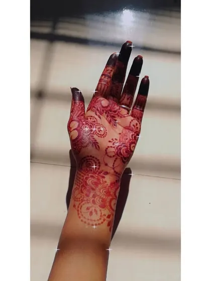 This glowing henna stain on the palm and wrist shows a mix of paisley and floral patterns. The rich color is a direct result of my fresh, organic henna paste.