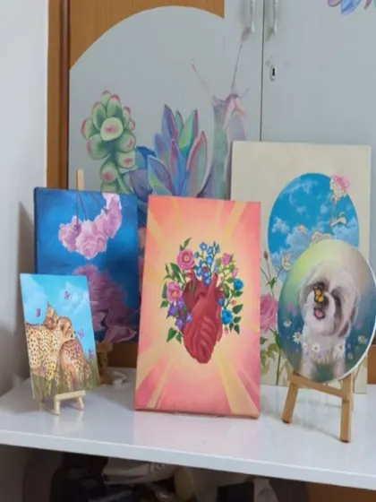 A collection of some of my recent canvas paintings displayed in my studio. This shows the variety of my smaller works, including a custom pet portrait, the floral heart, and other nature-inspired pieces, all done in my signature colorful style.