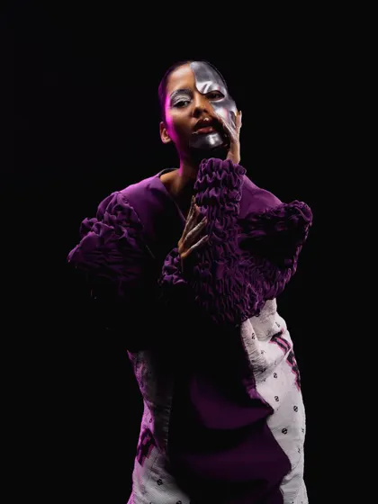 A portrait emphasizing the half-painted face and silver-tipped fingers, completing the futuristic concept.