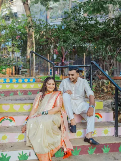 A relaxed and happy portrait of the couple sitting on colorful steps, capturing a casual and sweet interaction.