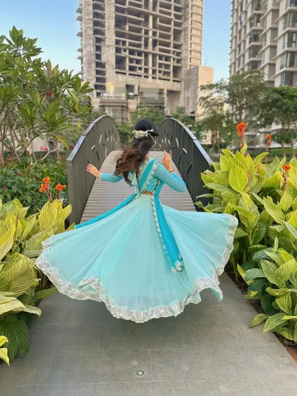 A candid shot from behind, showing the flow and movement of the costume and hair, all part of the dance's visual poetry.