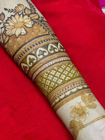This forearm design is composed of multiple bands of different patterns, including floral, geometric, and traditional motifs.
