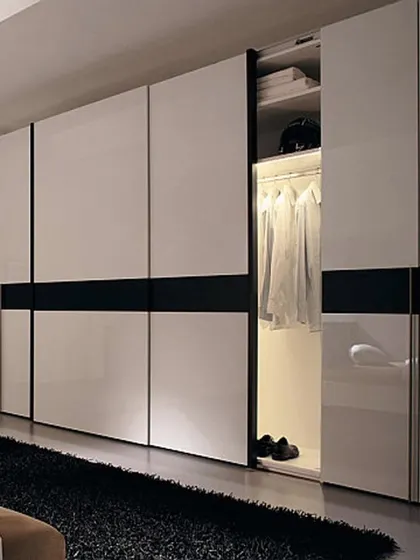 This conceptual design shows a large sliding wardrobe with high-gloss white shutters and a bold black accent stripe, creating a striking and modern aesthetic.