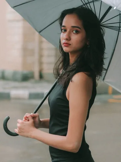 A classic portrait with an umbrella, where the subject's direct look connects with the viewer. Simple, elegant, and powerful.