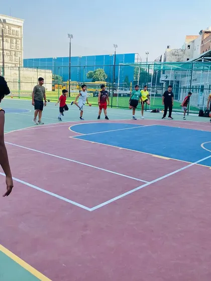 Players doing leg stretches to improve flexibility and prepare for explosive movements.