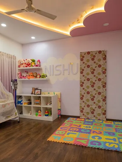 A sweet and serene nursery with a pastel pink and purple color scheme. The adorable penguin mural and cloud-shaped ceiling light create a magical environment for a baby.