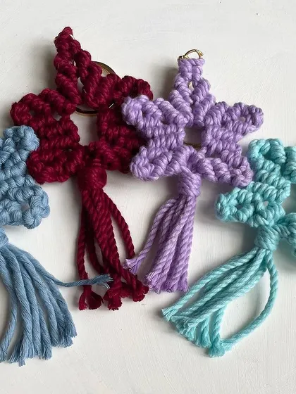 A collection of star keychains in shades of blue, burgundy, and purple. These are all made with earth-friendly cotton cord.