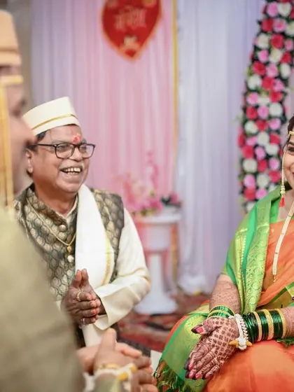 A candid moment of laughter and conversation with a family elder during the wedding ceremony.