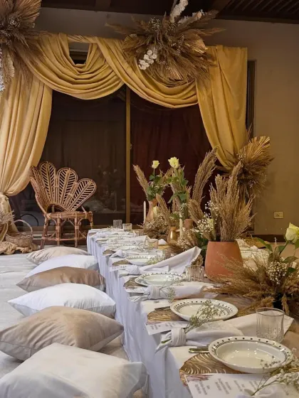 This intimate dinner was designed with an "Arabic Night" theme, featuring low floor seating on plush cushions and a warm, earthy color palette. The goal was to create a cozy and luxurious atmosphere for a pre-wedding celebration.