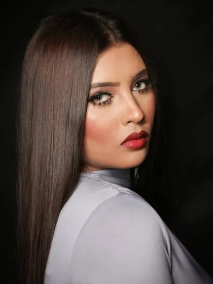 A profile shot that shows off the clean lines of the makeup and the model's features.