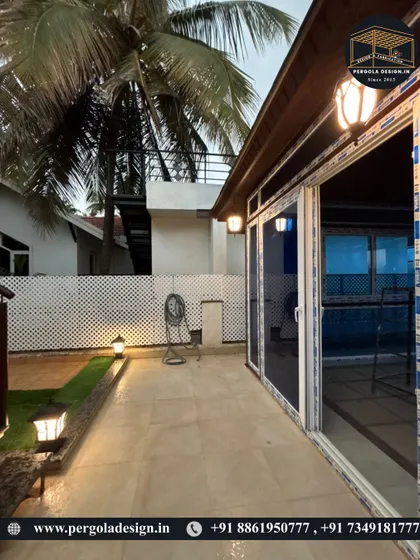 This side view at night highlights the seamless integration of the UPVC sliding doors and the ambient lighting scheme, which includes both wall-mounted fixtures and garden lights for a complete outdoor experience.
