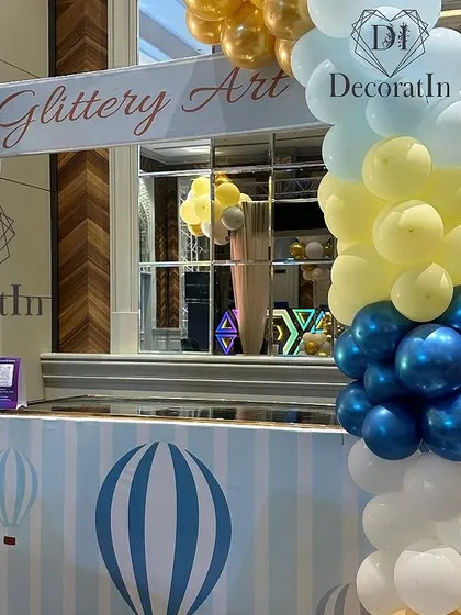 A "Glittery Art" station for kids, themed with hot air balloon designs to match the party.