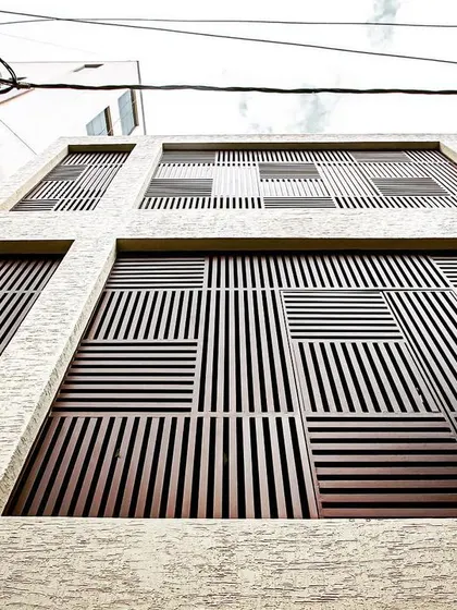 A worm's-eye view of the custom-designed screens, emphasizing the complex basket-weave pattern that provides both privacy and aesthetic appeal.